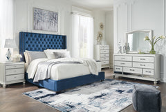 Coralayne California King Upholstered Bed with Mirrored Dresser and Chest - PKG010744